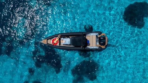 an aerial view of a boat in the water at Sigma Residences Boutique Hotel in Exámbela