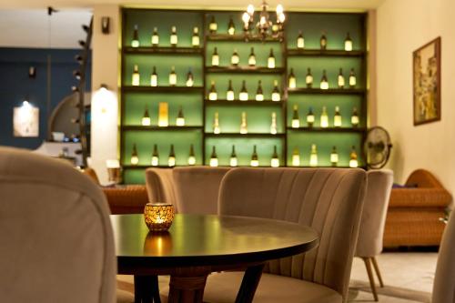 a table and chairs in a room with candles on a shelf at Fedra Mare in Agios Stefanos