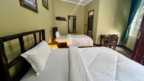 a bedroom with two beds in a room at Skill forest lodge in Arusha