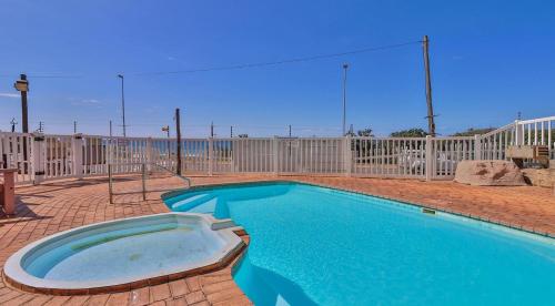 a swimming pool in front of a fence at Scottburgh Views - Piece of Paradise in Scottburgh