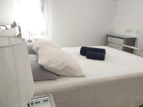 a large white bed with two pillows on it at El Rincón de San Fermín in Zizur Mayor