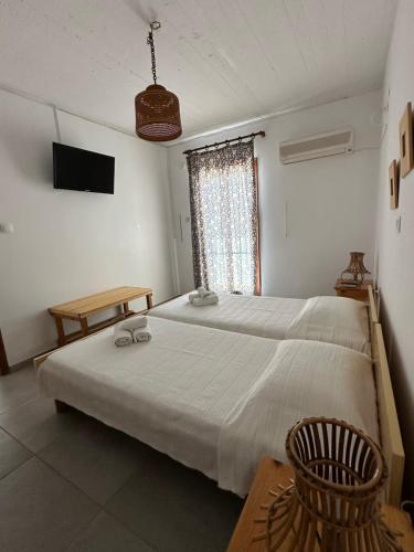 a bedroom with a large bed and a window at EL.DO.SO in Gavrio