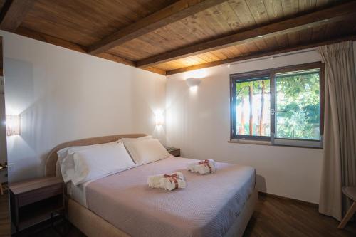 a bedroom with a bed with two dolls on it at Casa Rosaria Amalfi Coast in Vietri sul Mare