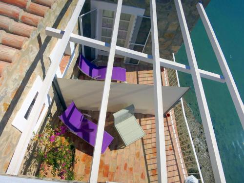 an overhead view of a balcony with purple chairs and the water at Moinhos das Marés in Fuzeta