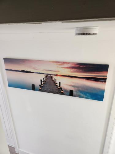 a painting of a pier over the water at Luxurious ensuite rooms in Basildon