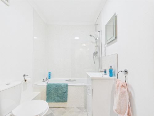a white bathroom with a sink and a toilet at The Low Crescent in Hawick