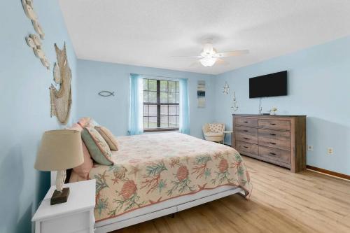 a bedroom with a bed and a dresser and a television at Sunnyside Retreat, Private pool, Bluewater Bay, Sleeps 11, Fenced Yard in Niceville