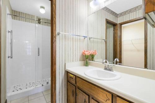 a bathroom with a sink and a shower at Sunnyside Retreat, Private pool, Bluewater Bay, Sleeps 11, Fenced Yard in Niceville