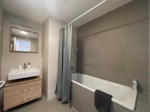 a bathroom with a sink and a tub and a mirror at SAG Sky park castle wiev Free parking Free wifi in Bratislava