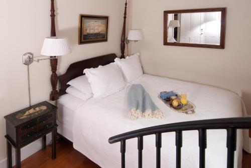 a bedroom with a bed with a tray of food on it at Marshall Slocum Inn in Newport