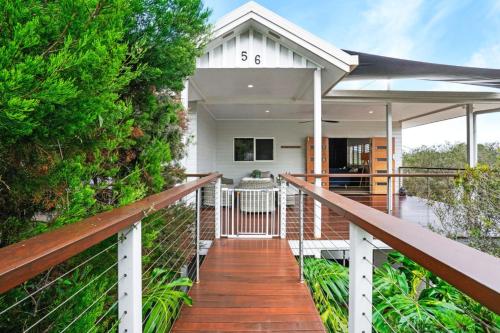 a home with a boardwalk leading to the front porch at Oleander Escape Lake Front Retreat in Yungaburra