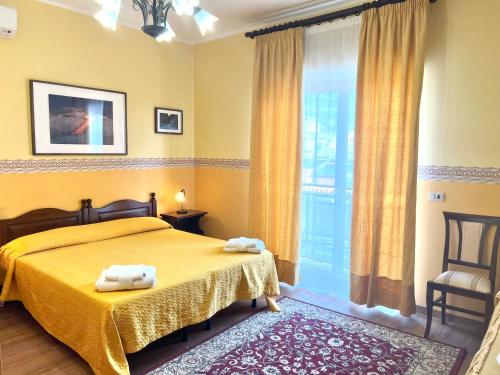 a bedroom with a bed with two towels on it at Ai Tre Parchi Bed And Bike in Randazzo
