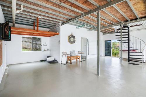 an empty room with a table and chairs in it at Oleander Escape Lake Front Retreat in Yungaburra