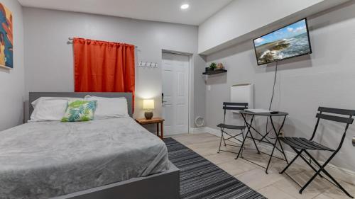 a bedroom with a bed and a table and chairs at Cozy and Private Studio w Outdoor Deck in St Petersburg