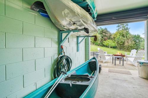 a boat is sitting on the side of a house at Oleander Escape Lake Front Retreat in Yungaburra