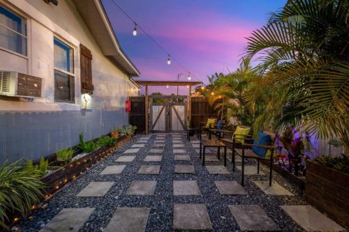 a patio with tables and chairs on a house at Cozy and Private Studio w Outdoor Deck in St Petersburg