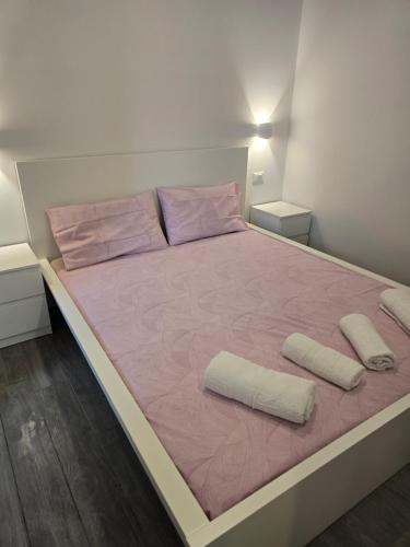 a bedroom with a large bed with pink sheets and pillows at adriano house in Milan
