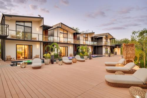 an outdoor patio with chairs and a building at The Bungalows Flamingo - 10 Unit Boutique Hotel in Playa Flamingo