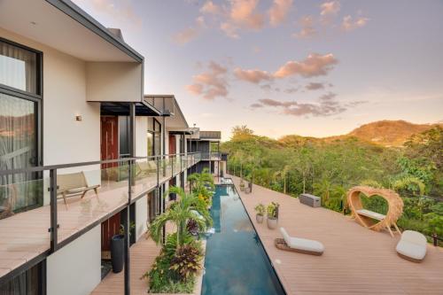 a house with a swimming pool on a balcony at The Bungalows Flamingo - 10 Unit Boutique Hotel in Playa Flamingo