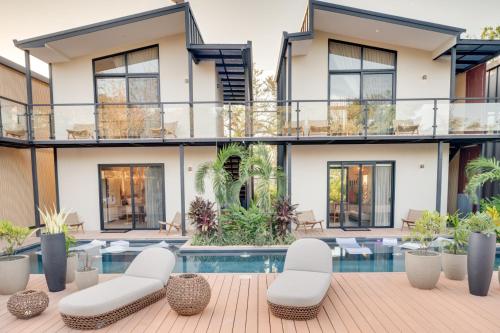 an exterior view of a house with a swimming pool at The Bungalows Flamingo - 10 Unit Boutique Hotel in Playa Flamingo