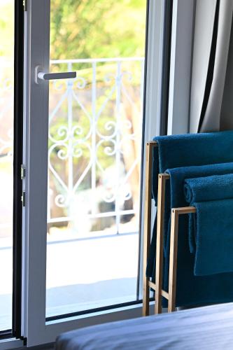 two blue chairs sitting next to a sliding glass door at Anchor Villa in Troulos