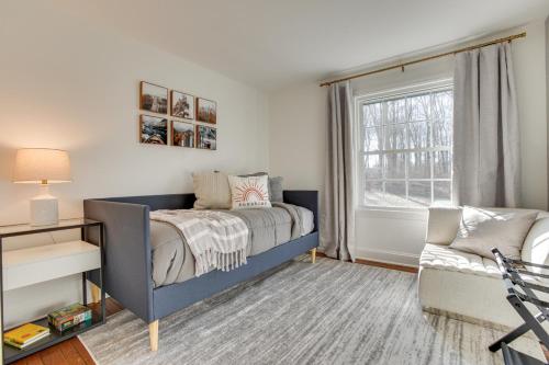 a bedroom with a blue bed and a window at Zook Manor with Hot tub Firepit and Game Room in Atglen