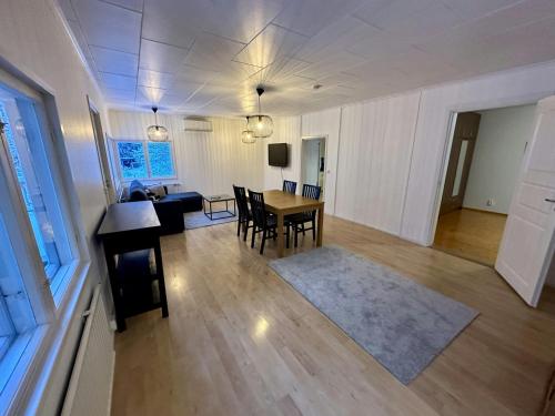 a living room with a table and a dining room at Central and Spacious Apartment for 4 with Sauna in Kaarina