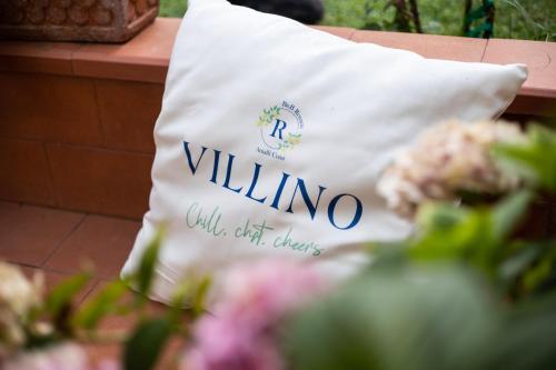 a white bag sitting on a table with flowers at Casa Rosaria Amalfi Coast in Vietri sul Mare