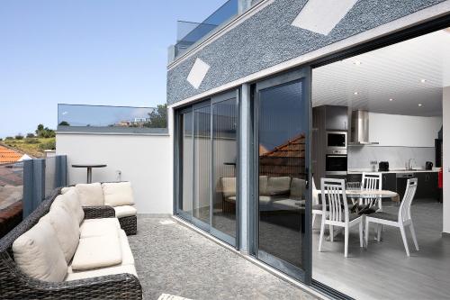 a balcony with a living room and a kitchen at ANGEL´S SUNSET in Estreito da Calheta