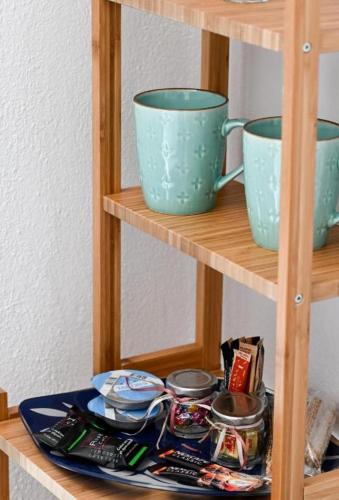 two blue cups and plates on a wooden shelf at Anchor Villa in Troulos