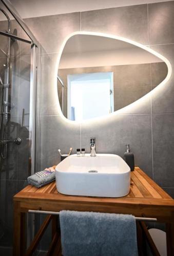a bathroom with a white sink and a mirror at Anchor Villa in Troulos