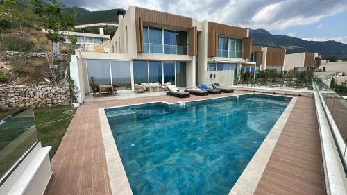 a house with a large swimming pool in front of it at Vila Palasea in Palasë
