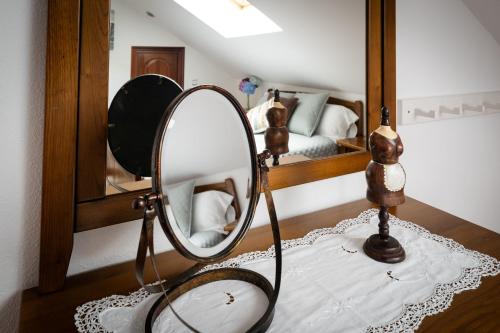 a mirror sitting on a table in a bedroom at Villa Pérez Rey in Dumbría