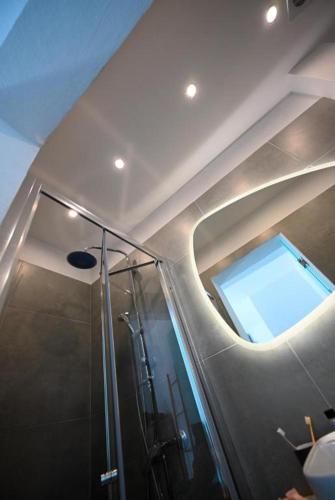 a bathroom with a glass shower with a window at Anchor Villa in Troulos