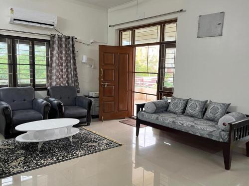a living room with a couch and a coffee table at Naidu Nivasam in Secunderabad