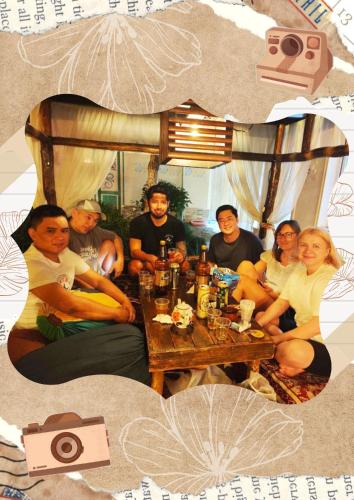 a group of people sitting around a table at DRIMIN - by Sunrise Caravan boutique Guesthouse and hostel in Tashkent