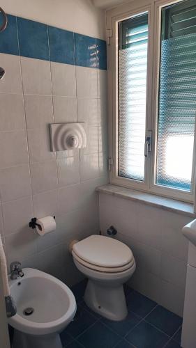 a bathroom with a toilet and a sink at La casa di Nonna Rosa in Procida