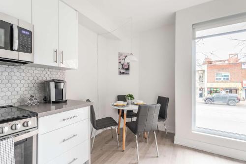 a kitchen with a table and chairs and a window at Beautifully Furnished 3BR Apartment Close to High Park Neatest Intersection Lane N Bloor E Indian Rd in Toronto