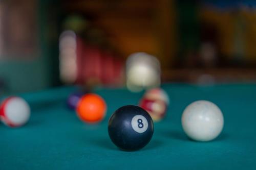 a billiard eight ball on a pool table at Lake Arenal Hotel & Brewery in Tilarán