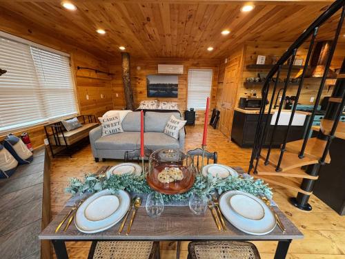 a living room with a table in a cabin at SkyView treehouse in Belgrade