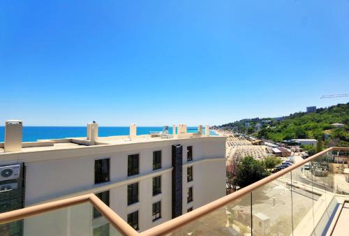 a view of the beach from the balcony of a building at Cabacum Pleasure Beachfront Apartments in Varna City