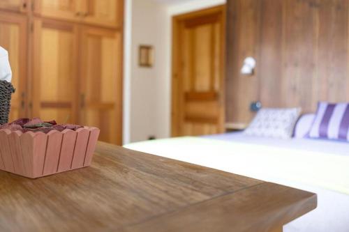 a room with a bed and a table with a bowl on it at Agriturismo Au Jardin Fleuri in Antey-Saint-André