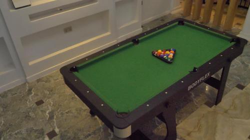a pool table with a pile of balls on it at Vanora Shortlets in Akobo