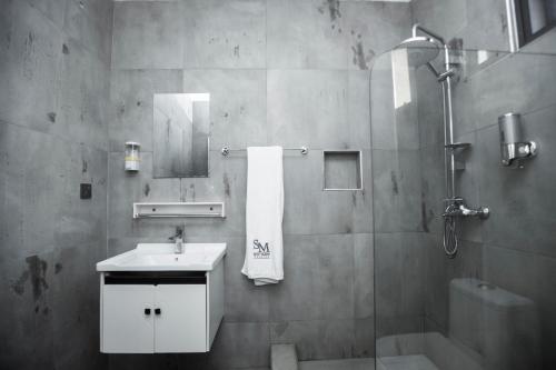 a bathroom with a sink and a shower at Self made Estates in Accra