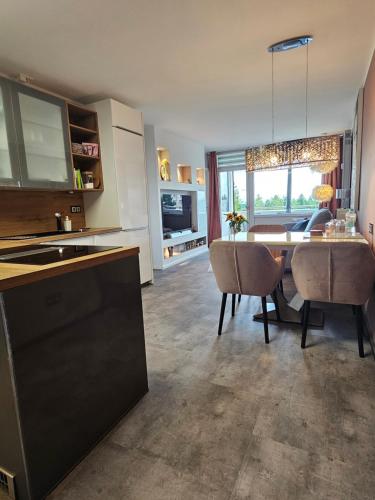 a kitchen and dining room with a table and chairs at Harz High End Fewo Exklusiv 5 Sterne DTV in Hahnenklee-Bockswiese