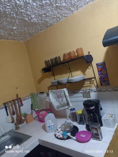 a kitchen counter with items on a counter top at Apartamento Luna Bella in Quetzaltenango