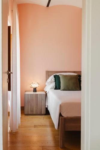 a bedroom with a bed and a wooden floor at Tenuta Borgo Santa Cecilia in Gubbio