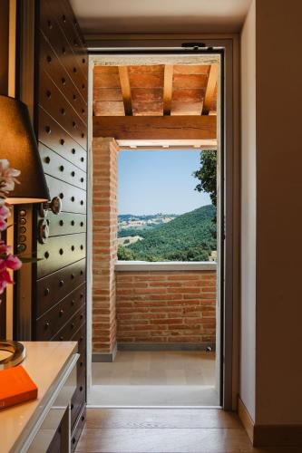 an open door with a window in a kitchen at Tenuta Borgo Santa Cecilia in Gubbio