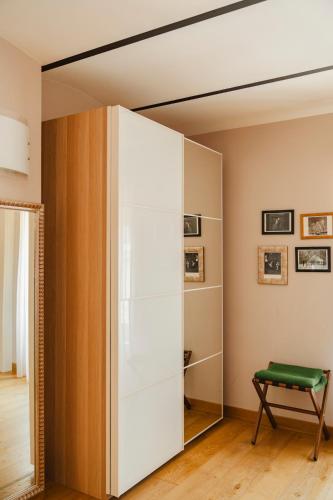 a large white cabinet in a room with a green bench at Tenuta Borgo Santa Cecilia in Gubbio