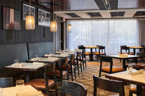 a dining room with long tables and chairs at Doubletree By Hilton Raleigh Crabtree Valley in Raleigh